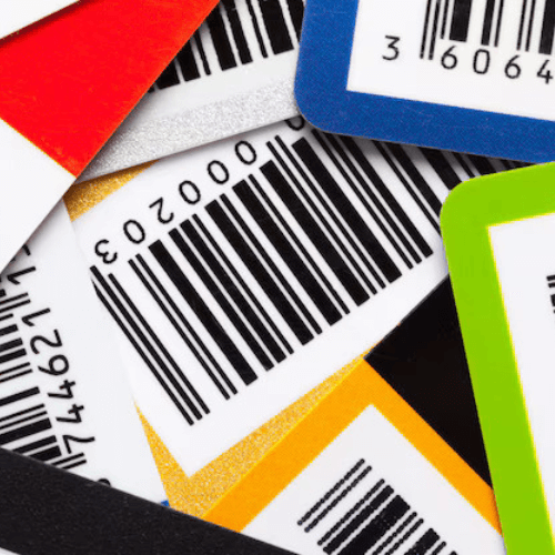 A collection of colorful cards with printed barcodes stacked together.