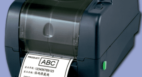 A label printer printing a barcode label on a blue background.