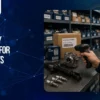 Technician scanning barcode labels on automotive spare parts with inventory management software in a warehouse.